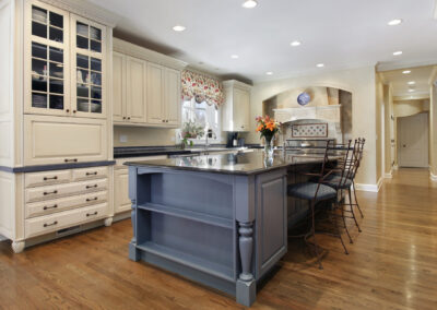 Upscale kitchen with a gray cabinet and granite island